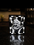 Black and white Art the Clown portrait with top hat and geometric border displayed in a black light-up frame