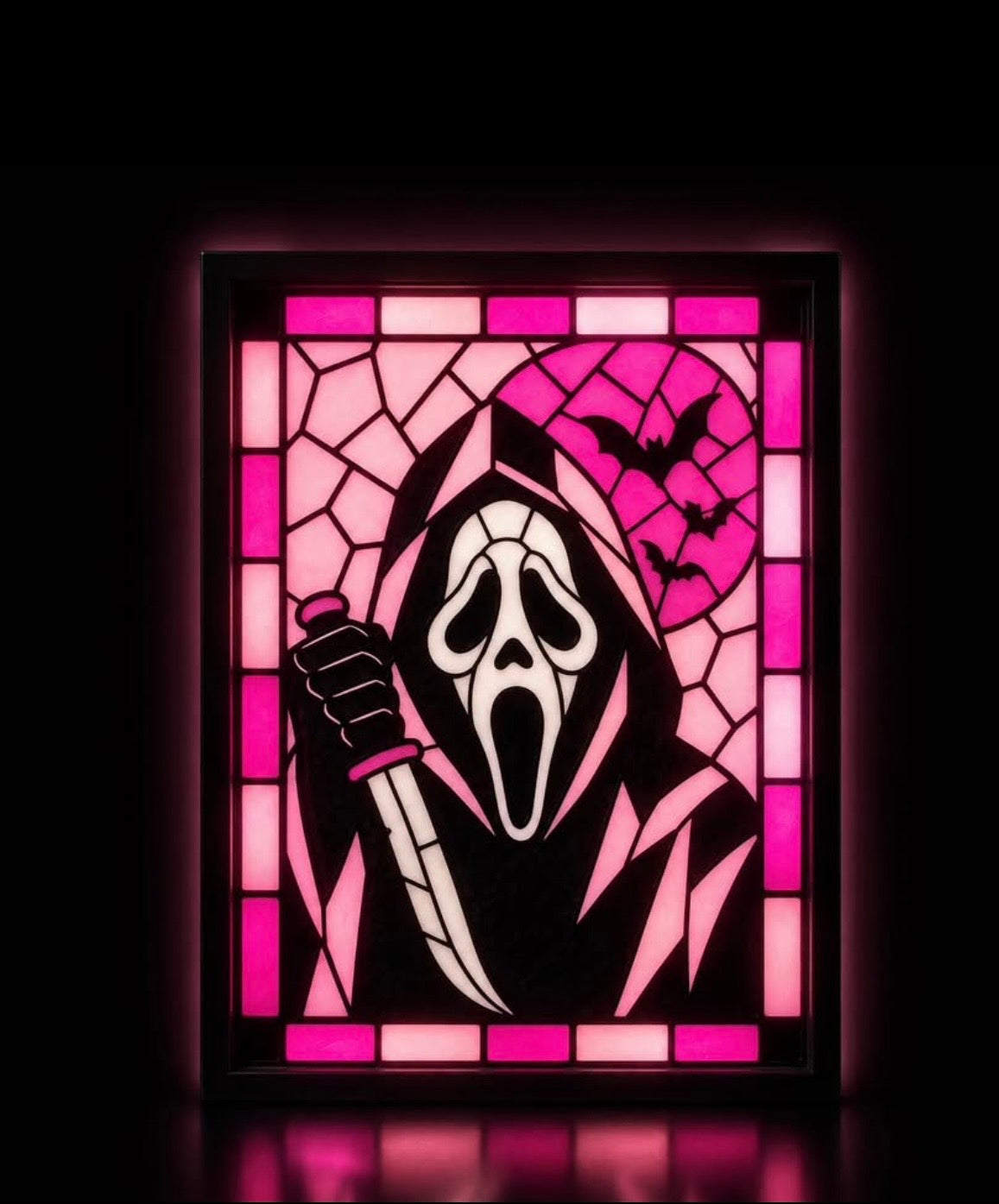 Pink Ghostface portrait with moon, bats and geometric border displayed in a black light-up frame