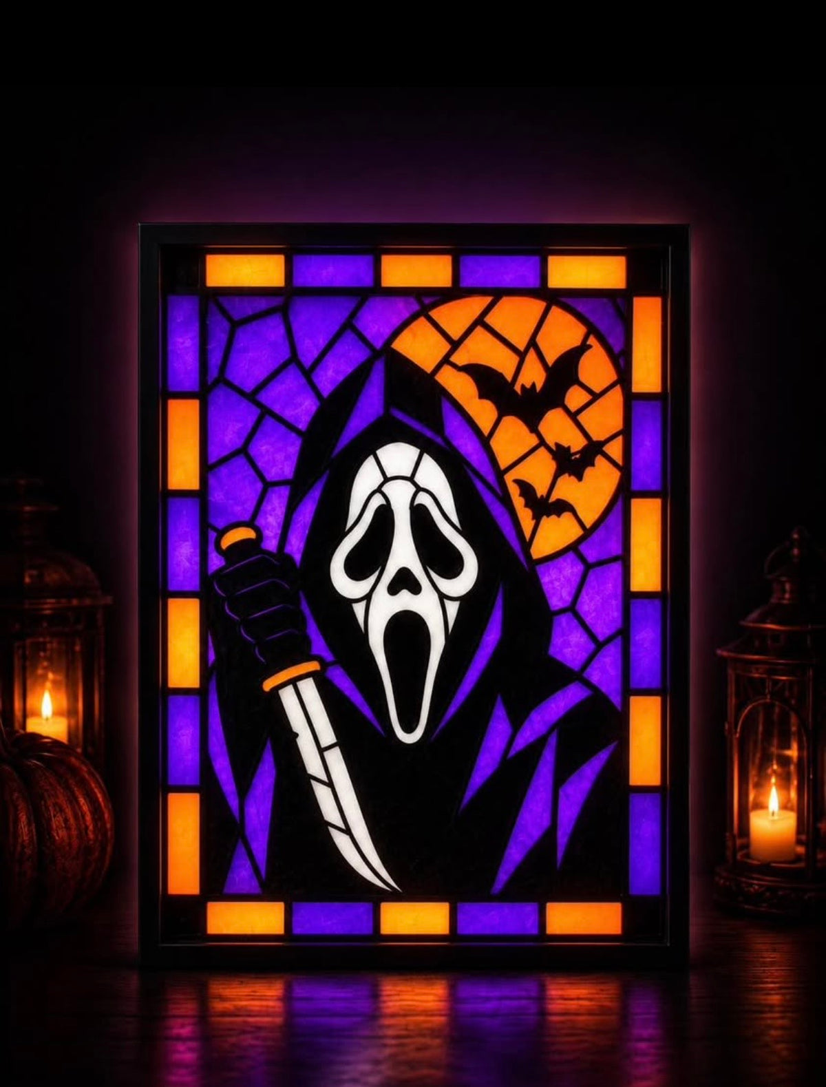 Purple and orange Ghostface portrait with bats and moon displayed in a black light-up frame
