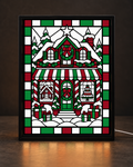 Christmas bakery window with red green and white stained-glass-style tiles in slim black tabletop frame; illustrative digital preview