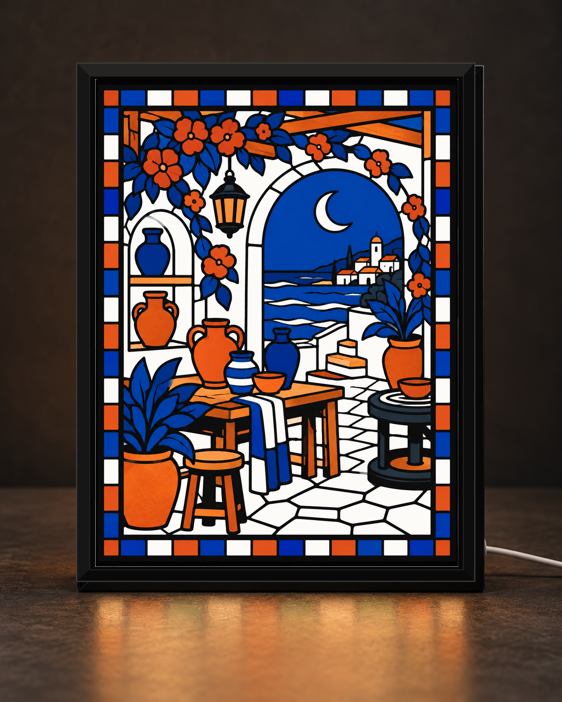 Illustrative CNS Customs light-up frame mockup of Moonlit Coastal Pottery Terrace, featuring cobalt-blue water and pottery, orange flowers, a crescent moon, and a slim black tabletop frame