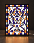 Illustrative framed preview of two-tier ornamental fountain with purple and orange iris blossoms in matte black light-up frame
