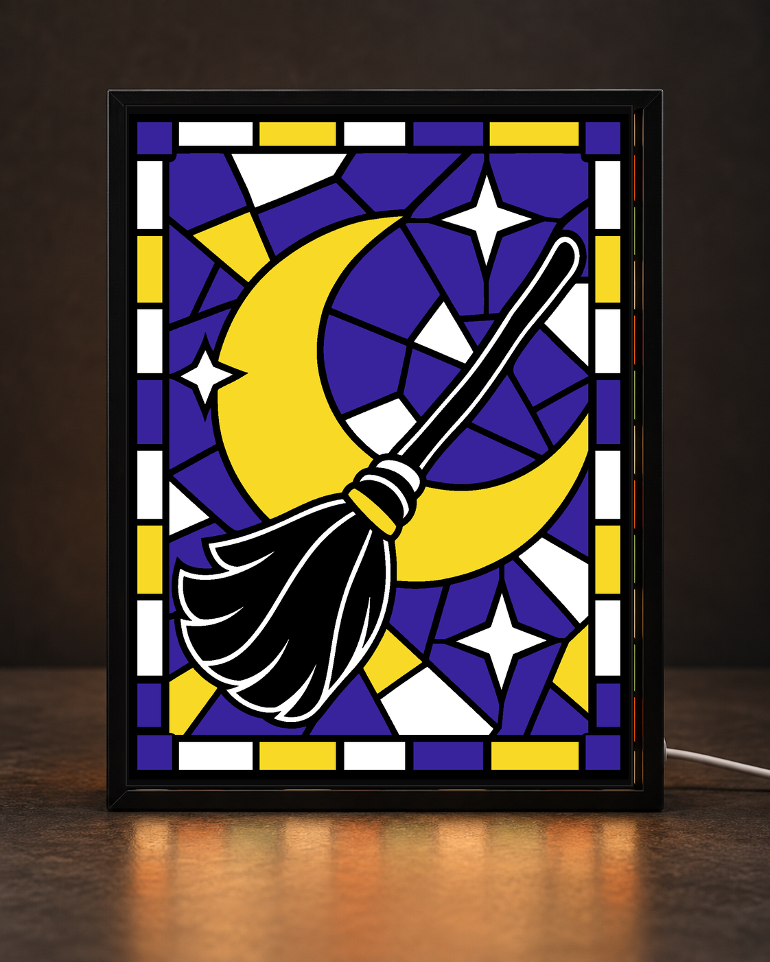 Black broom crossing a yellow crescent moon with white stars on purple mosaic stained-glass-style artwork inside slim black light-up frame; illustrative digital framed preview